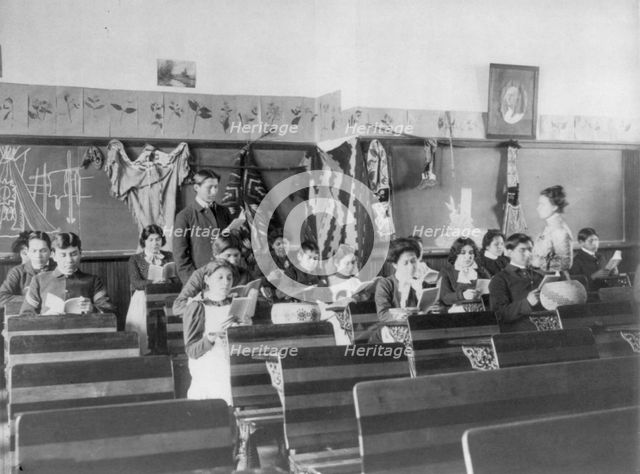 Male and female students reading in class, Carlisle Indian School, Carlisle, Pennsylvania, 1901. Creator: Frances Benjamin Johnston.