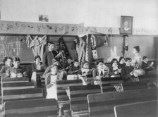 Male and female students reading in class, Carlisle Indian School, Carlisle, Pennsylvania, 1901. Creator: Frances Benjamin Johnston