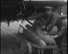 Male British Officers Loading Bombs Onto a Plane, 1920s Creator: British Pathe Ltd