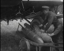Male British Officers Loading Bombs Onto a Plane, 1920s Creator: British Pathe Ltd