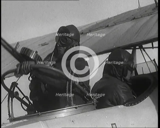 Male British Pilots On Board a Plane And Mounting a Machine Gun, 1920s. Creator: British Pathe Ltd.