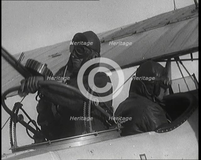 Male British Pilots On Board a Plane And Mounting a Machine Gun, 1920s. Creator: British Pathe Ltd.