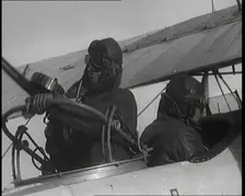Male British Pilots On Board a Plane And Mounting a Machine Gun, 1920s. Creator: British Pathe Ltd