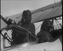 Male British Pilots On Board a Plane And Mounting a Machine Gun, 1920s. Creator: British Pathe Ltd