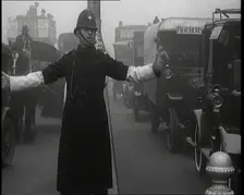 Male British Police Officer Controlling the Traffic On the Streets of London, 1920s. Creator: British Pathe Ltd