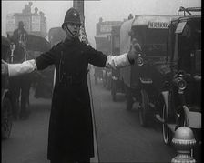 Male British Police Officer Controlling the Traffic On the Streets of London, 1920s. Creator: British Pathe Ltd