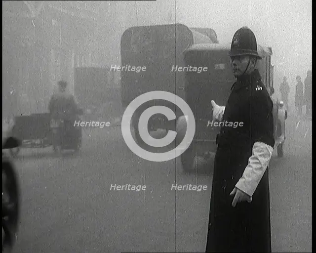 Male British Police Officer Controlling the Traffic On the Streets of London, 1920s. Creator: British Pathe Ltd.