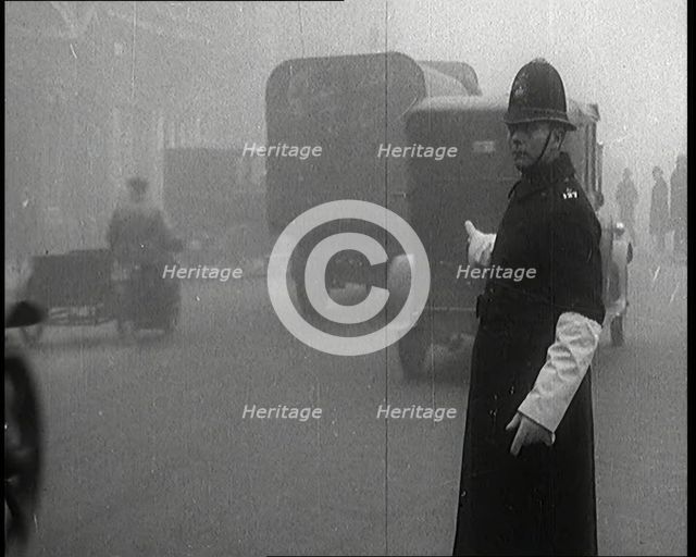 Male British Police Officer Controlling the Traffic On the Streets of London, 1920s. Creator: British Pathe Ltd.