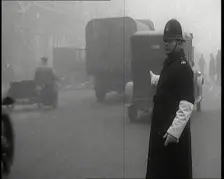 Male British Police Officer Controlling the Traffic On the Streets of London, 1920s. Creator: British Pathe Ltd