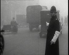 Male British Police Officer Controlling the Traffic On the Streets of London, 1920s. Creator: British Pathe Ltd