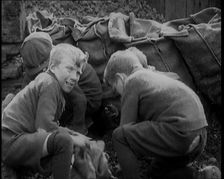 Male Children Picking Through Small Heaps of Coal on the Ground , 1924. Creator: British Pathe Ltd