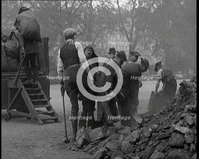 Male Civilian Volunteers Shovelling Heaps of Coal in Hyde Park London, 1926. Creator: British Pathe Ltd.