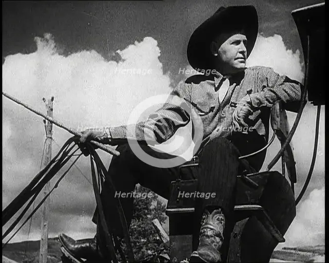 Male Civilian With a Cowboy Hat Sitting On a Coach Waiting For Passengers, 1932. Creator: British Pathe Ltd.