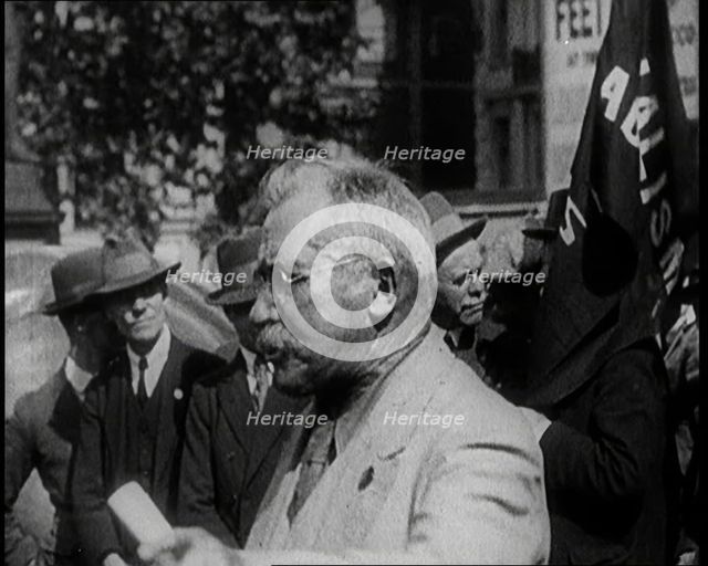 Male Civilian With Small Round Glasses and a Moustache Speaking.  Behind Are Male Civilians..., 1924 Creator: British Pathe Ltd.