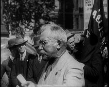 Male Civilian With Small Round Glasses and a Moustache Speaking. Behind Are Male Civilians..., 1924 Creator: British Pathe Ltd