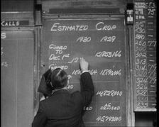 Male Civilian Writing the Newest Stock Prices On a Blackboard, 1932. Creator: British Pathe Ltd
