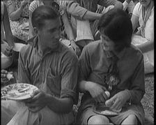 Male Civilian and Female Civilian Enjoying a Picnic Outdoors, 1920. Creator: British Pathe Ltd