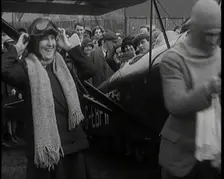 Male Civilian And Female Civilian Standing in Front of an Airplane Putting On an Aviator's..., 1927 Creator: British Pathe Ltd