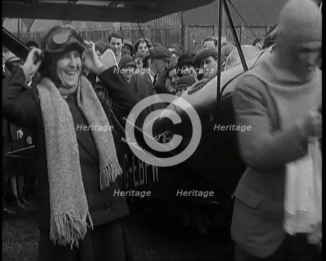 Male Civilian And Female Civilian Standing in Front of an Airplane Putting On an Aviator's..., 1927 Creator: British Pathe Ltd.