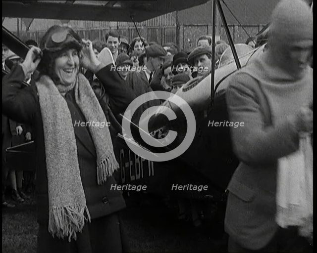 Male Civilian And Female Civilian Standing in Front of an Airplane Putting On an Aviator's..., 1927 Creator: British Pathe Ltd.