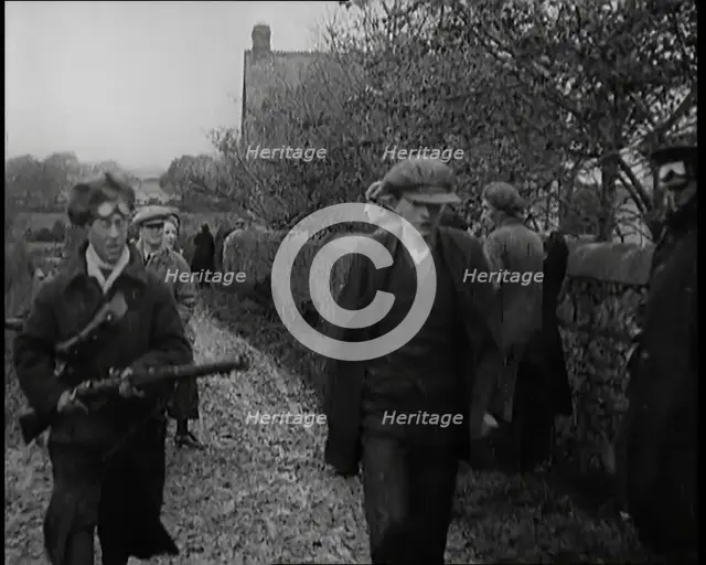 Male Civilian Being Arrested and Escorted Along a Country Lane by a Police Officer, 1920s. Creator: British Pathe Ltd.