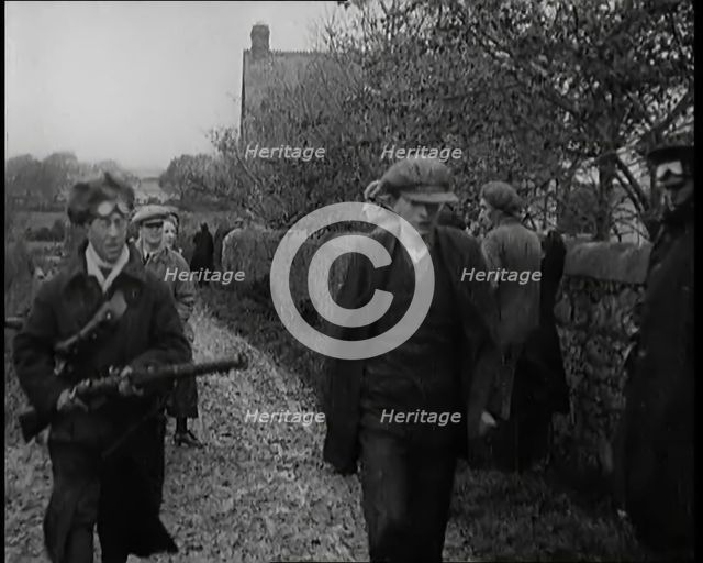 Male Civilian Being Arrested and Escorted Along a Country Lane by a Police Officer, 1920s. Creator: British Pathe Ltd.
