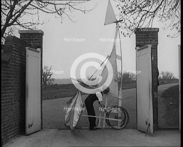 Male Civilian Carrying a Small Pedal Powered Flying Machine and Trying to Demonstrate It in a..., 19 Creator: British Pathe Ltd.