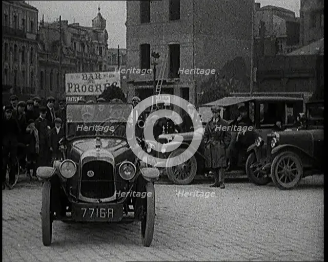 Male Civilian Driving a Car Out of a Parking Space On the Streets of London Watched By..., 1920s. Creator: British Pathe Ltd.