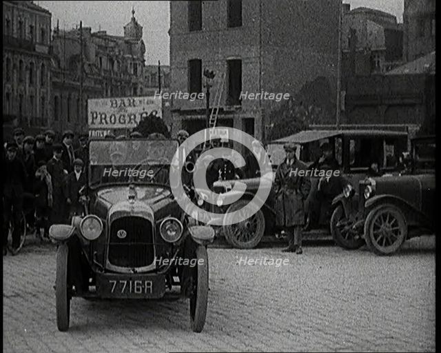 Male Civilian Driving a Car Out of a Parking Space On the Streets of London Watched By..., 1920s. Creator: British Pathe Ltd.