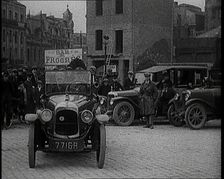 Male Civilian Driving a Car Out of a Parking Space On the Streets of London Watched By..., 1920s. Creator: British Pathe Ltd