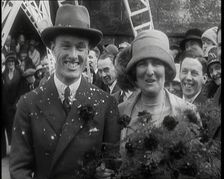 Male Civilian (Groom) And Female Civilian (Bride) Emerging from a Church To Walk Through an...,1920s Creator: British Pathe Ltd
