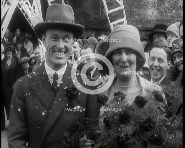 Male Civilian (Groom) And Female Civilian (Bride) Emerging from a Church To Walk Through an...,1920s Creator: British Pathe Ltd.
