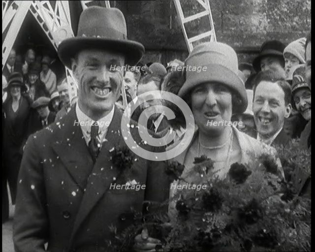 Male Civilian (Groom) And Female Civilian (Bride) Emerging from a Church To Walk Through an...,1920s Creator: British Pathe Ltd.