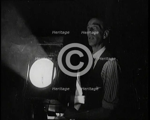 Male Civilian Stands Next to a Large Light, 1920s. Creator: British Pathe Ltd.