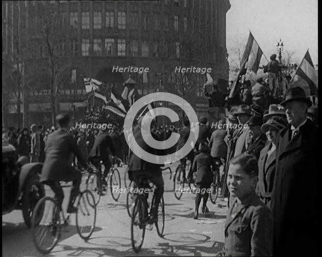 Male Civilians Driven in Trucks Parade Waving Flags. Other Male Civilians Ride Alongside on..., 1924 Creator: British Pathe Ltd.