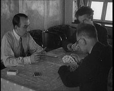 Male Civilians Playing Cards in Gondola of the Zeppelin, 1929. Creator: British Pathe Ltd