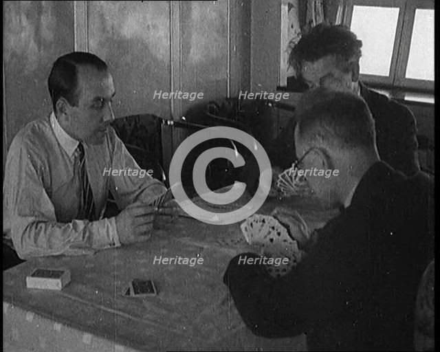 Male Civilians Playing Cards in Gondola of the Zeppelin, 1929. Creator: British Pathe Ltd.