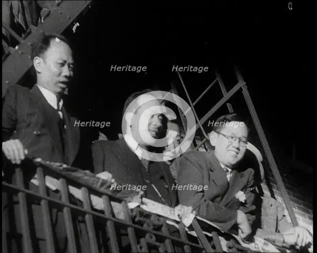 Male Civilians Watching a Female Civilian in Traditional Robe Performing With Sabres in..., 1932. Creator: British Pathe Ltd.