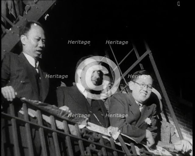 Male Civilians Watching a Female Civilian in Traditional Robe Performing With Sabres in..., 1932. Creator: British Pathe Ltd.