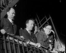 Male Civilians Watching a Female Civilian in Traditional Robe Performing With Sabres in..., 1932. Creator: British Pathe Ltd