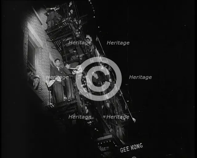 Male Civilians Watching a Female Civilian in Traditional Robe Performing With Sabres..., 1932. Creator: British Pathe Ltd.