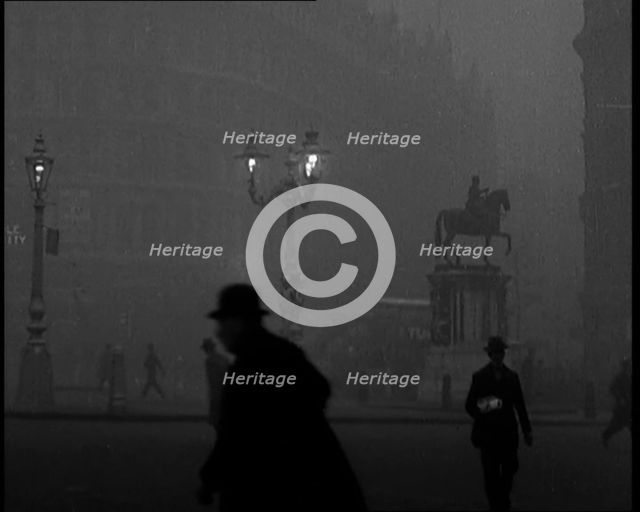 Male Civilians Walking Through the Foggy Streets of London, 1929. Creator: British Pathe Ltd.