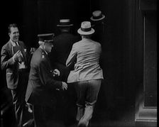 Male Civilians Walking in to a Building, 1929. Creator: British Pathe Ltd