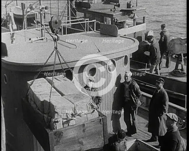Male Civilians Unloading Illegal Cargo from a Boat, 1932. Creator: British Pathe Ltd.
