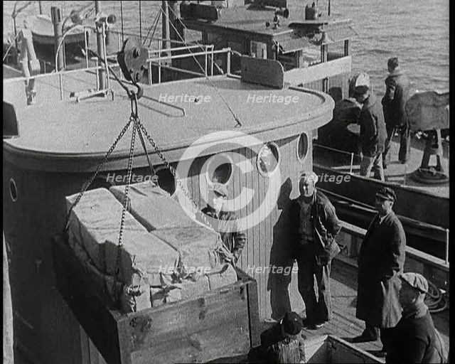 Male Civilians Unloading Illegal Cargo from a Boat, 1932. Creator: British Pathe Ltd.
