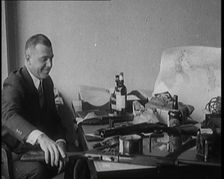 Male Detective Showing off Smugglers Captured Guns, 1929. Creator: British Pathe Ltd