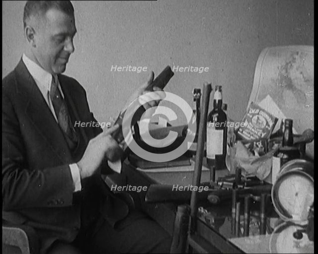 Male Detective Showing off Smugglers' Captured Guns, 1929.  Creator: British Pathe Ltd.