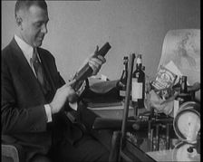 Male Detective Showing off Smugglers Captured Guns, 1929. Creator: British Pathe Ltd