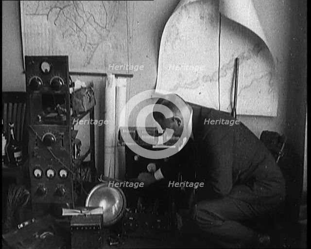 Male Detective Showing off Smugglers' Radio Equipment, 1929. Creator: British Pathe Ltd.