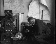 Male Detective Showing off Smugglers Radio Equipment, 1929. Creator: British Pathe Ltd